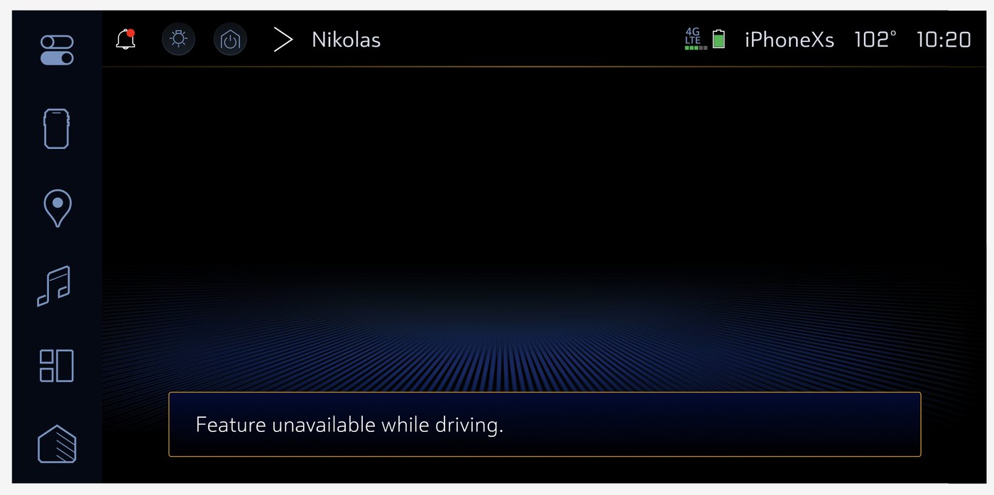 In-vehicle message: Feature unavailable while driving.